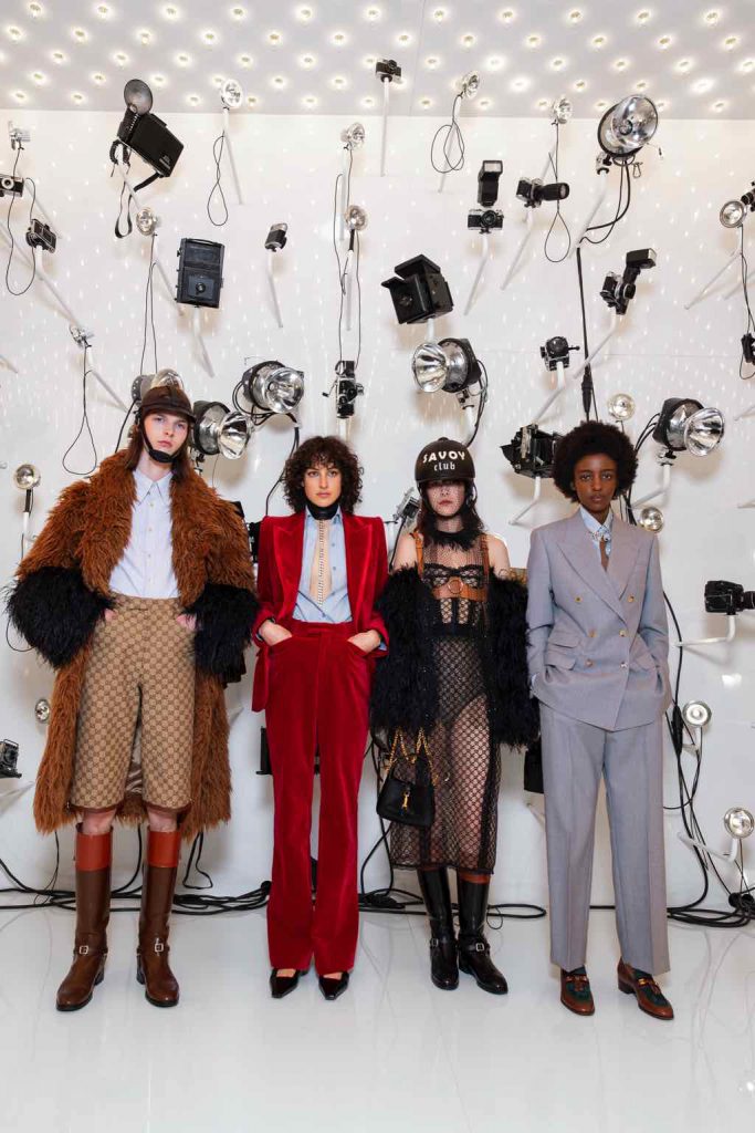 Fashion models showcasing a variety of high-end outfits from the Gucci Aria collection