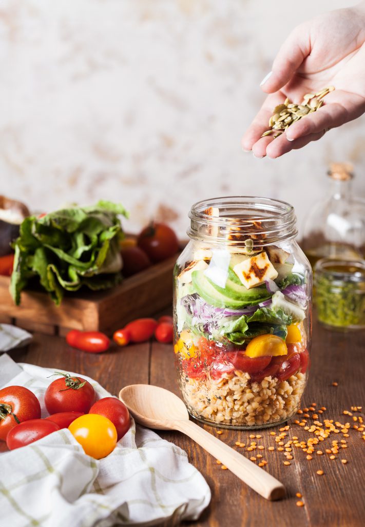Salad ngũ cốc tươi ngon trong lọ thủy tinh với hạt hướng dương rắc trên cùng