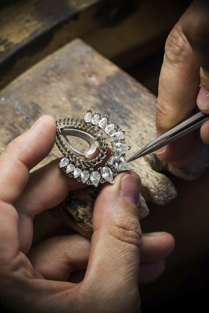 Thợ kim hoàn đang gắn đá quý lên chiếc nhẫn bằng nhíp tinh xảo