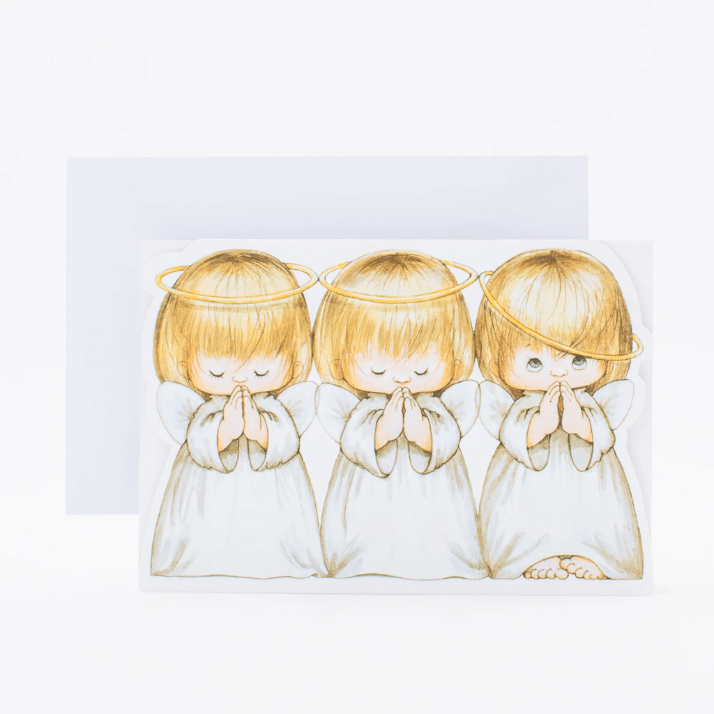 Three praying angels with halos are featured on a vintage Christmas card