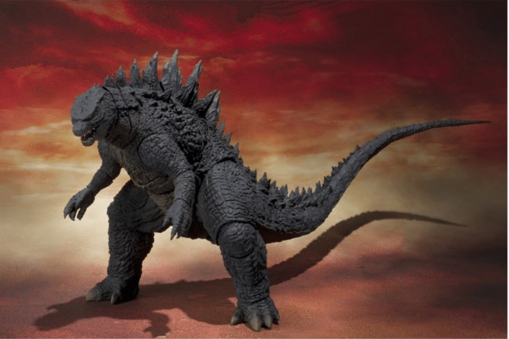 Godzilla với hình dáng mạnh mẽ đứng trên nền trời đỏ rực đầy khí thế