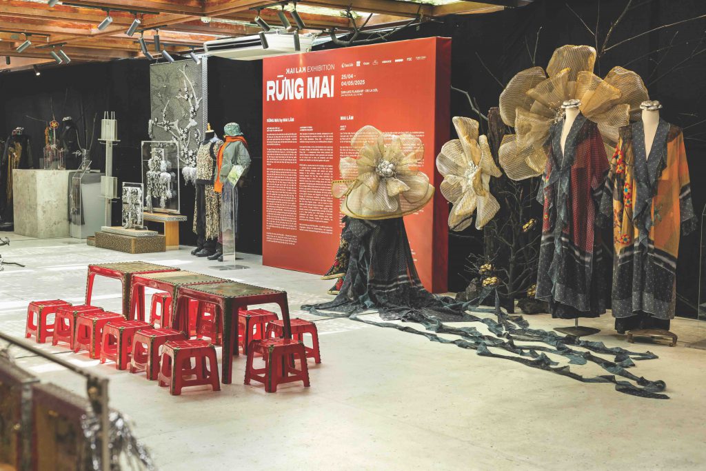 An art installation features clothing on mannequins and large floral sculptures