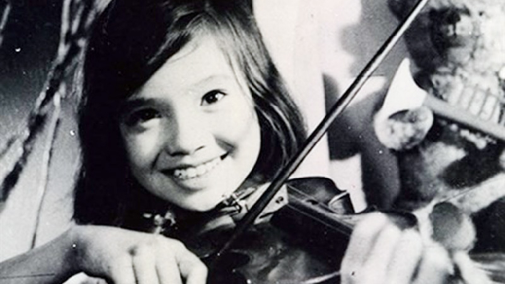 Cô bé mỉm cười rạng rỡ khi đang chơi đàn violin