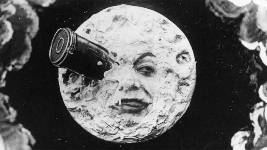 Mặt trăng được nhân cách hóa với khuôn mặt người và ống kính máy ảnh lớn gắn trên bề mặt